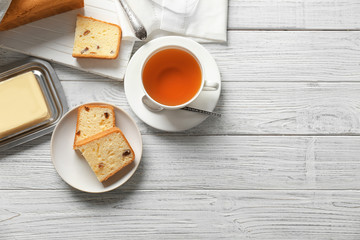 Plate with delicious sliced butter cake on wooden table