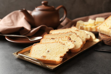 Tray with delicious sliced butter cake on  table