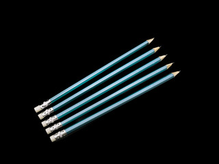 Five Blue Pencils isolated Black background