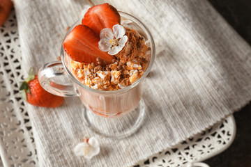 Delicious yogurt parfait with strawberry in glass on table