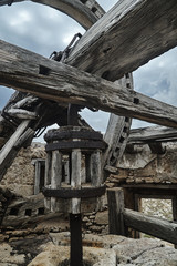 Fototapeta premium Destroyed wooden mechanism of a traditional Greek windmill.