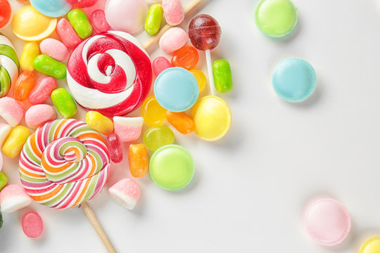 Tasty colorful candies on white background