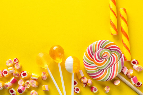 Tasty candies on color background