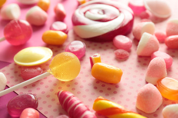 Fototapeta na wymiar Tasty candies on color background, closeup