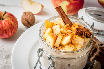 Healthy vegan food. Dietary breakfast or snack. Apple pie overnight oats, with apples, yogurt,...