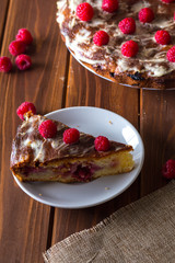 Summer pie with raspberries on a dark wooden background