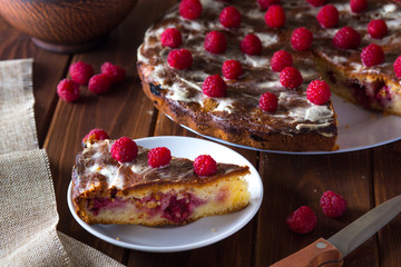 Summer pie with raspberries on a dark wooden background