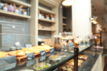 Blurred view of counter with bakery products in shop