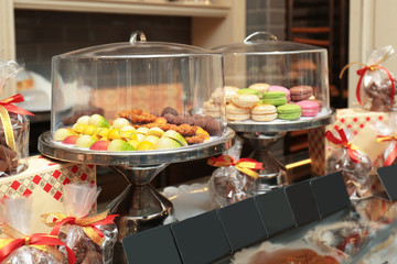 Stands with tasty sweets on table in shop