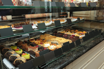 Fridge with cakes in shop