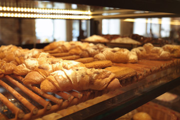Counter with bakery products in shop, closeup