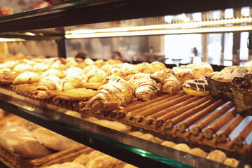 Counter with bakery products in shop, closeup