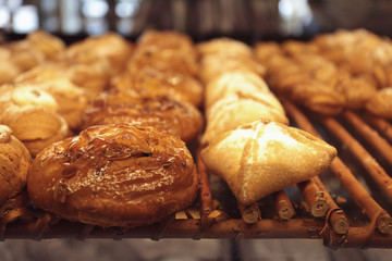 Counter with bakery products in shop, closeup
