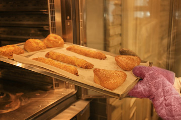 Woman holding tray with bakery products