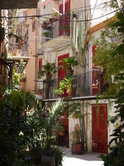 Fototapeta na wymiar Rue aux fenêtres rouges à Palerme