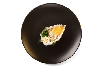Delicious oyster on a black plate