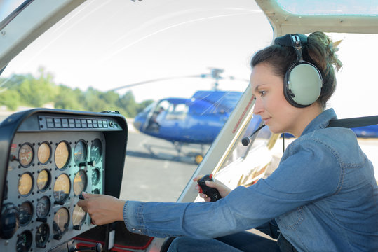 Woman at the controls of a helicopter