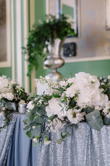 White floral decoration of the table in the restaurant