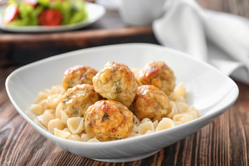 Bowl with turkey meatballs and pasta on table, closeup
