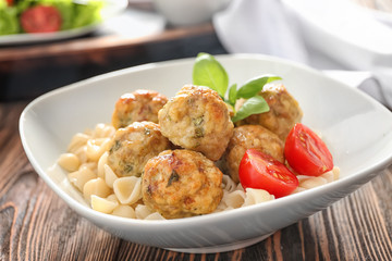 Bowl with turkey meatballs and pasta on table, closeup