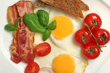Delicious breakfast with over easy eggs on plate, closeup