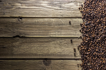 Coffee beans on background from old wooden planks. Top view. Flat lay. Rustic style