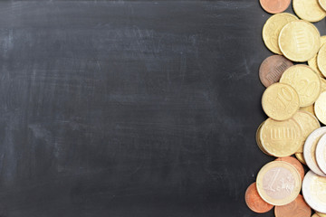 Blackboard background with coins on side