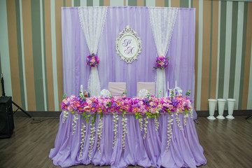 Wedding in lilac color. Decor of the banquet. The table is newlywed from flowers and fabrics