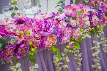 Wedding in lilac color. Decor of the banquet. The table is newlywed from flowers and fabrics