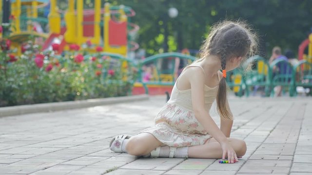 Child Drawing a Mother and a Child Near a House, Little Girl Drawing on Asphalt