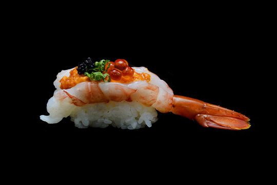 Botan ebi sushi or Spacial premium king shrimp sushi mixed by ikura and caviar top on Japanese rice. Japanese tradition food with black isolated background