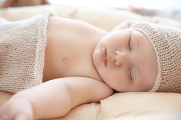 Cute little baby sleeping on lounge at home, closeup