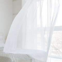 Closeup of white waving curtain in bedroom with window - obrazy, fototapety, plakaty