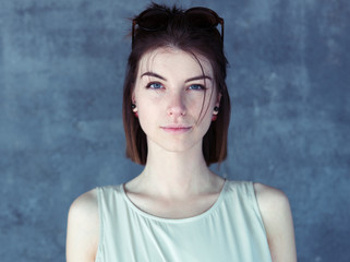 Portrait of a young beautiful woman, blue background