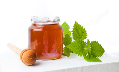 Honey jar and stinging nettle leaves