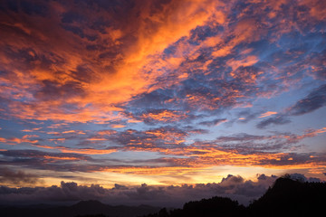 orange - blue sunset over tropical hills in Kulon Progo mountains Java island Indonesia - the night is coming