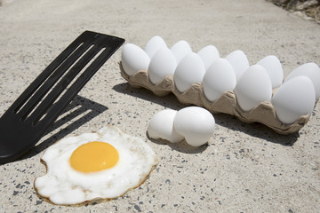 Eggs frying on sidewalk