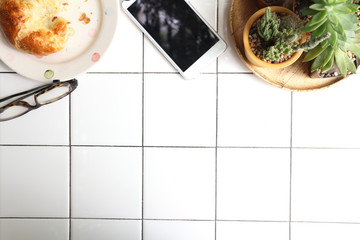 Fresh baked croissants in kitchen , croissant on floor, glasses  ,cell-phone