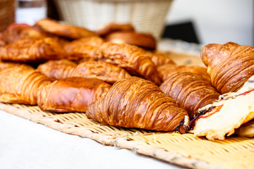 Fresh croissants lay on the counter of a small shop