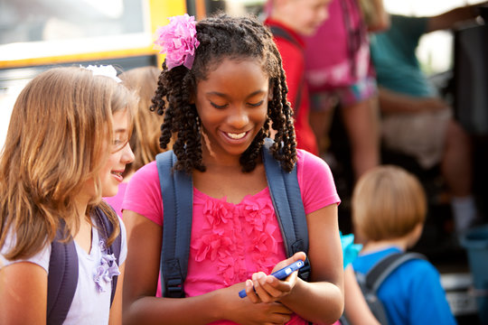 School Bus: Kids Use Cell Phone in Line