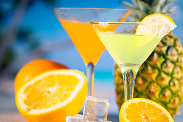 Yellow and orange drink with fruits, summer time background