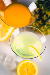 Yellow and orange drink with fruits, summer time background