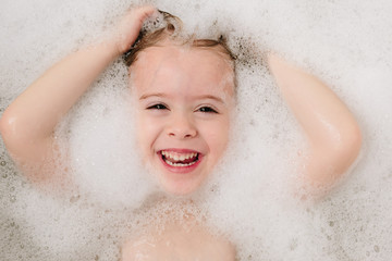 girl washing her hair in bubble bath