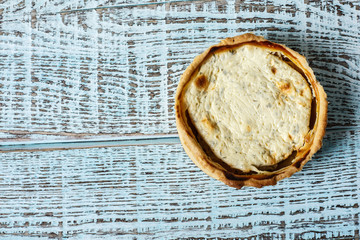 Australian meat pie on the table, a horizontal top view, rustic style. Homemade australian meat pie on the wooden table. Delicious cut meat pie on a plate. American Chicken pot pie