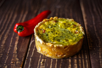 Australian meat pie on the table, a horizontal top view, rustic style. Homemade australian meat pie on the wooden table. Delicious cut meat pie on a plate. American Chicken pot pie