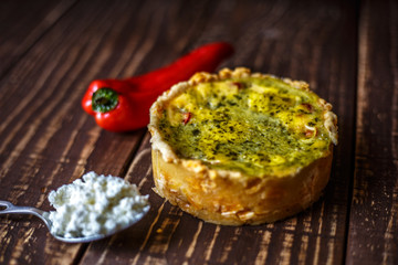 Australian meat pie on the table, a horizontal top view, rustic style. Homemade australian meat pie on the wooden table. Delicious cut meat pie on a plate. American Chicken pot pie