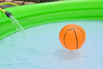 Inflatable swimming pool full of water with various children's games