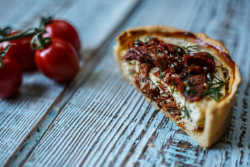 Australian meat pie on the table, a horizontal top view, rustic style. Homemade australian meat pie on the wooden table. Delicious cut meat pie on a plate. American Chicken pot pie