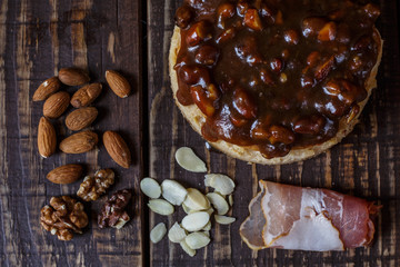 Australian meat  pie on the table and avocado, chilli, chips, rustic style. Homemade meat pie on the wooden table. Delicious cut meat pie on a plate. American Chicken pot pie