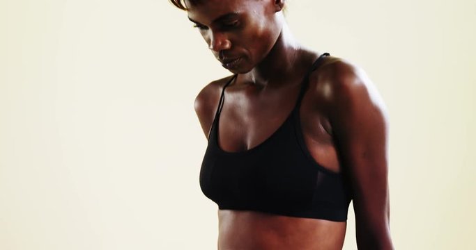 Androgynous person in sportswear posing against white background